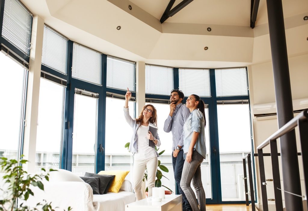 Agent touring a couple in a house