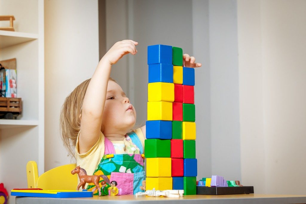 Little girl playing with toys