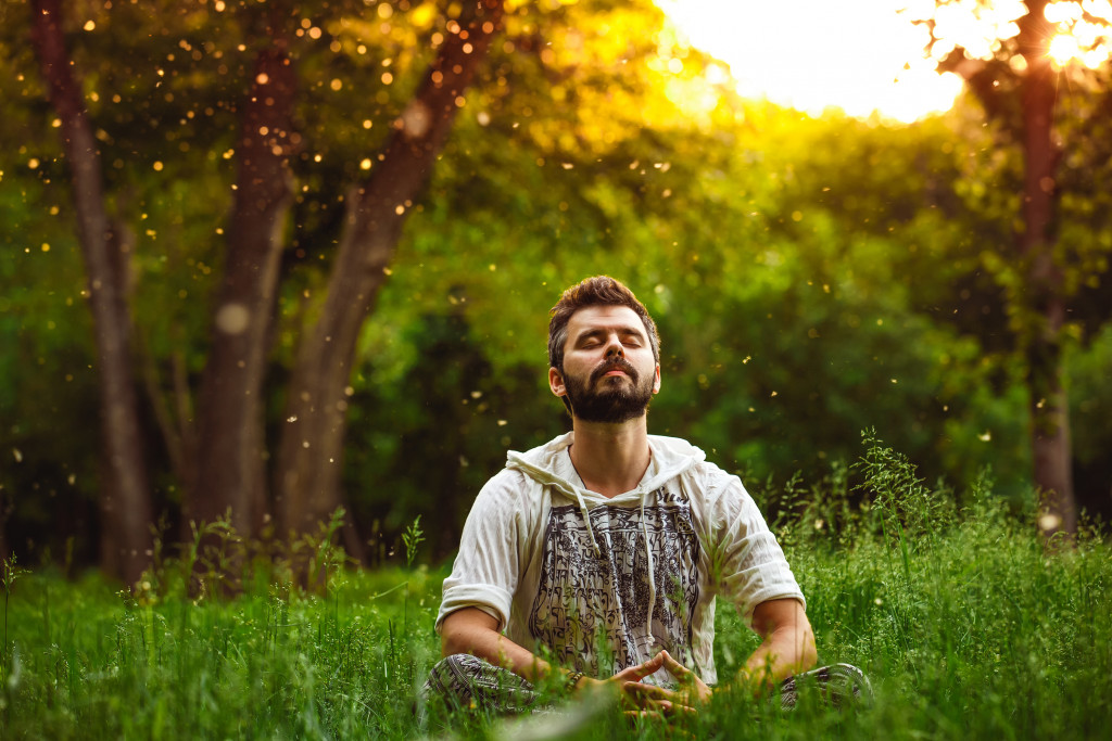man meditating in forest concept