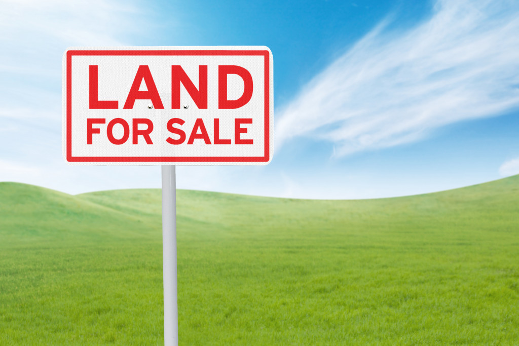 grassland with land for sale signage on it