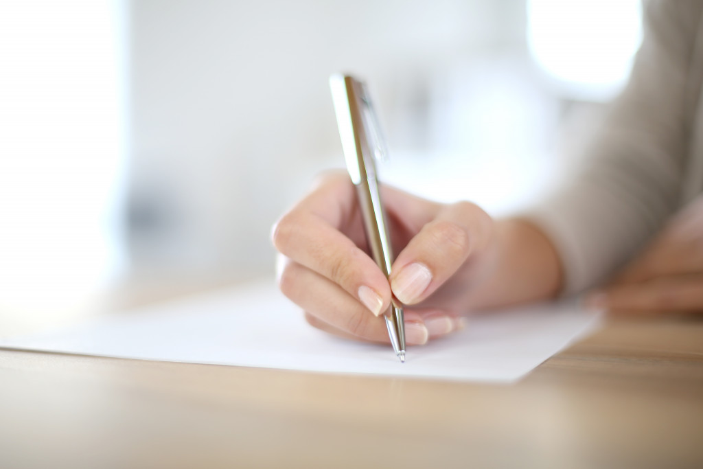 A woman signing a legal document