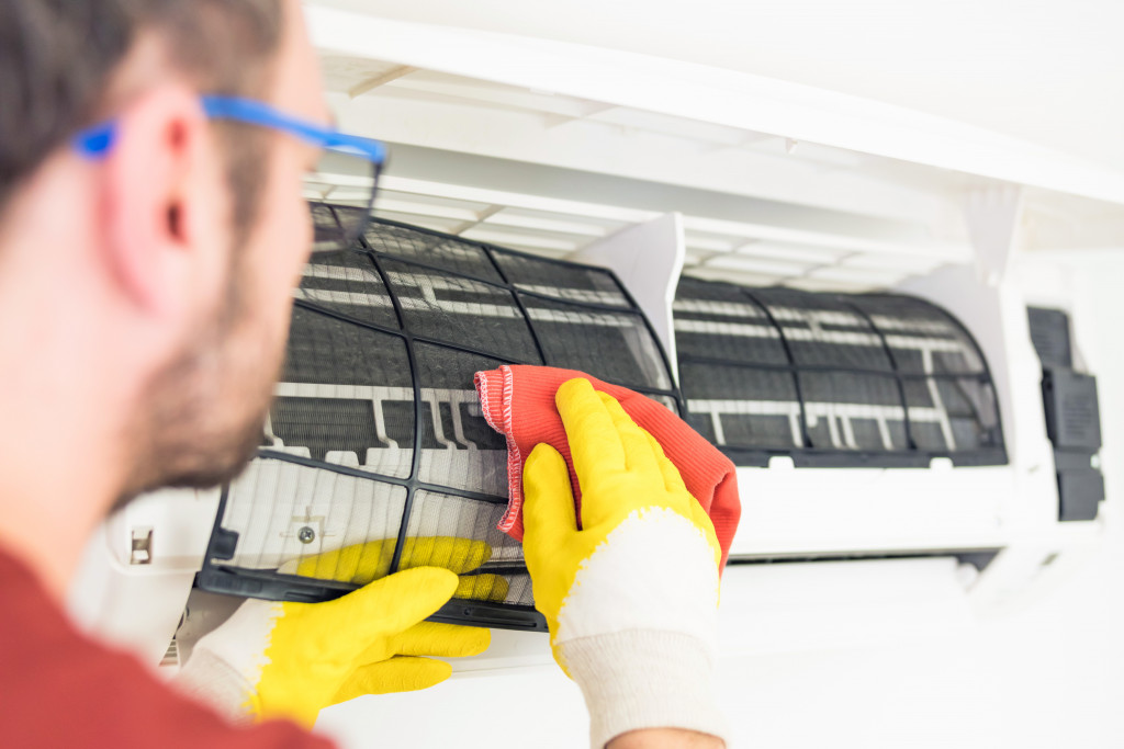 Professional service cleaning an air conditioning filter